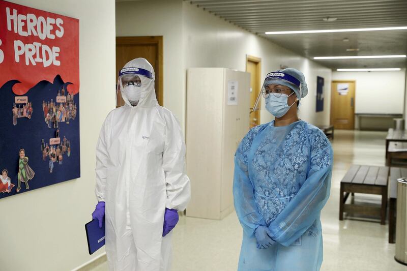 DUBAI, UNITED ARAB EMIRATES , August 10 – 2020 :-  Nurses outside the isolation room wearing PPE kit. Pool changing area converted into isolation room at the Dubai American Academy in Dubai. New Covid safety setup in different areas of the school such as hand sanitizer, safety message, social distancing stickers pasted on the floor, thermal cameras will be installed at the entrance of the school. School will open on 30th August. (Pawan Singh / The National) For News/Online/Instagram. Story by Sarwat Nasir