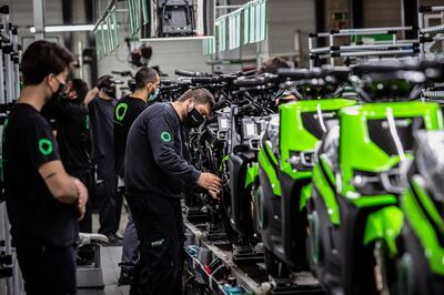 Workers install components onto S02 electric motorcycles on the assembly line at the Silence Urban Ecomobility plant in the Sant Boi de Llobregat district of Barcelona, Spain, on Wednesday, April 29, 2021. Spain plans to invest 13.2 billion euros ($15.7 billion) to boost electric vehicle use, one of a raft of measures as the government prepares to deploy European Union pandemic recovery funds to modernize the economy, Prime Minister Pedro Sanchez said. Photographer: Angel Garcia/Bloomberg
