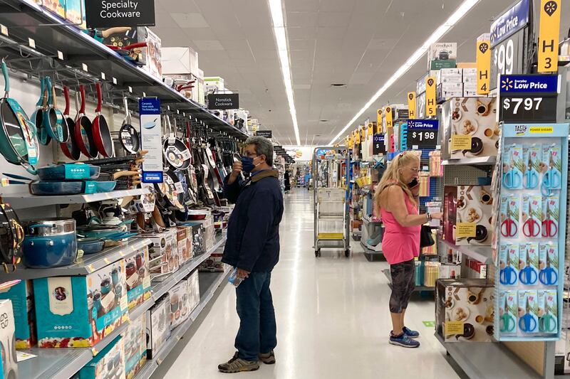 Consumers shop at a Walmart store in the US. Annual inflation remained stable at 5.4% in the country following six consecutive months of increases. AP