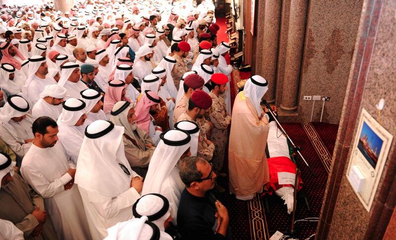 Mourners at Sheikh Shakhbout Mosque pray over the body of Abdulhamid Sultan Al Hammadi, at the funeral prayers of Al Hammadi and Mohammed Ali Al Bastaki, who's body has yet to be recovered from the scene of the terror attack. Wam