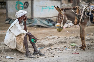 An elderly man waits to refill his donkey-drawn water tank in Port Sudan in the Red Sea State of war-torn Sudan. AFP