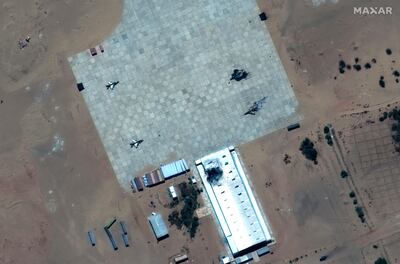 A satellite image shows a destroyed fighter aircraft and damaged hangar at Merowe airbase, approximately 330km north of Khartoum. AP