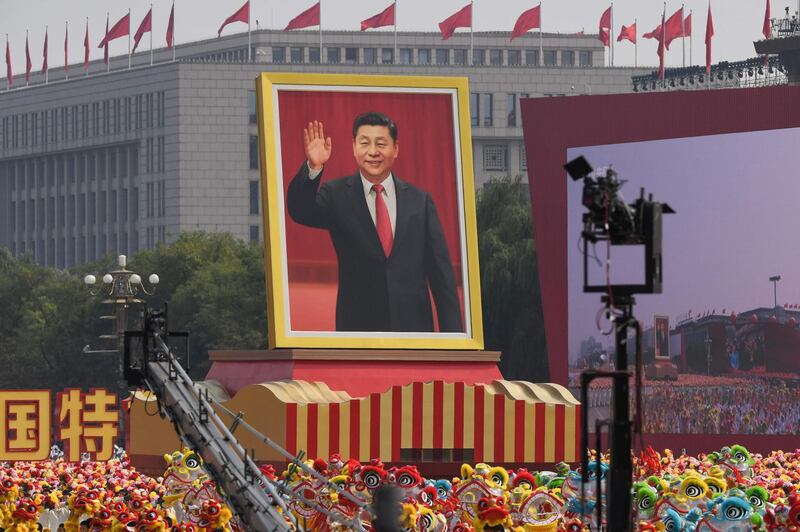 A float with a giant portrait of Chinese President Xi Jinping passes by Tiananmen Square. AFP