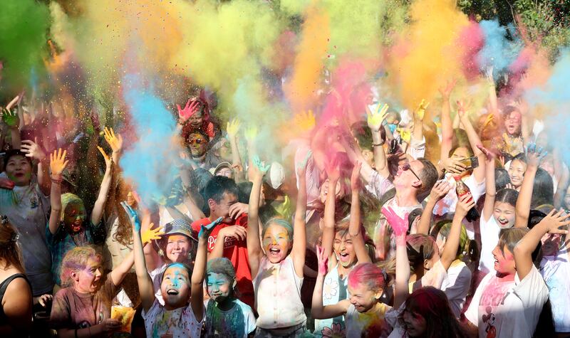 Young people take part in the Festival of Colours at Asanbai Park in Bishkek, Kyrgyzstan.  The event refers to the traditional Holi festival in northern India.  EPA