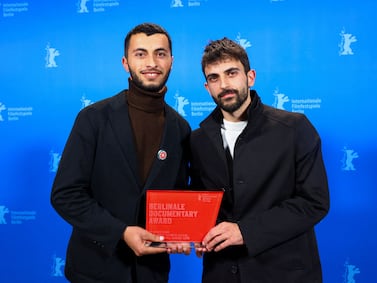 Basel Adra, left, and Yuval Abraham at the Berlin International Film Festival. Their film about the West Bank won best documentary. AFP