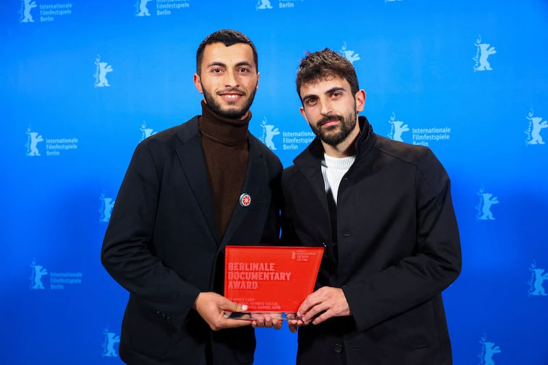 Basel Adra, left, and Yuval Abraham at the Berlin International Film Festival. Their film about the West Bank won best documentary. AFP