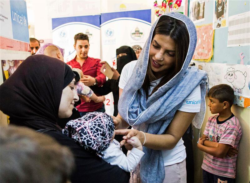 Priyanka Chopra, a UNICEF Goodwill Ambassador, greets a Syrian woman and her baby at UNICEF's Makani Center in Amman, Jordan, Sunday, Sep. 10, 2017. Chopra said the world needs to do more to help those displaced by war -- through individual donations if governments won't step up. The Bollywood veteran who is increasingly making her mark in the U.S. also tells The Associated Press in an interview that she didn't realize until working in America that it's "difficult for a woman of color" to be cast in a wide range of roles. (AP Photo/Lindsey Leger)