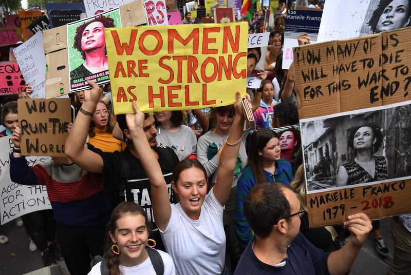 People hold up banners as thousands march to mark International Women's Day in Melbourne.  AFP