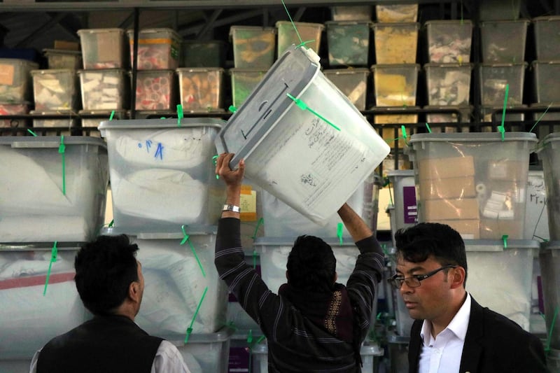 epa07111113 Workers of Independent Election Commission (IEC) shift ballot boxes to a warehouse after parliamentary elections in Herat, Afghanistan, 22 October 2018. Afghan President Ashraf Ghani on 21 October officially announced that voting in the Afghan parliamentary elections had closed, with initial data from the election commission estimating that over four million eligible voters exercised their democratic rights over the weekend.  EPA/JALIL REZAYEE
