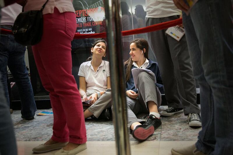 Farah Abed, 15, right, studies for their biology exam while queuing for One Direction tickets with her friend Leen Seifo, 15 at Abu Dhabi Mall. Silvia Razgova / The National