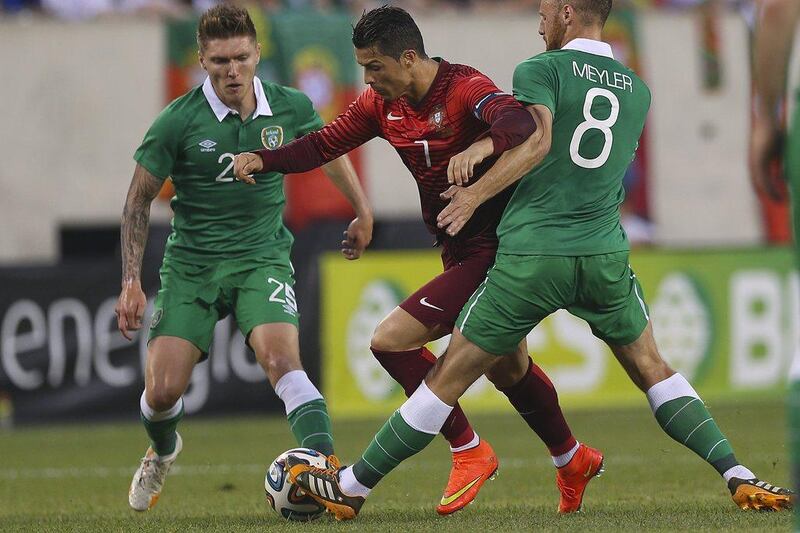 Cristiano Ronaldo of Portugal in action against the Ireland's Stephen Kelly, left, and David Meyler, right, during their World Cup 2014 international friendly warmup on Tuesday. Jose Sean Goulao / EPA / June 10, 2014