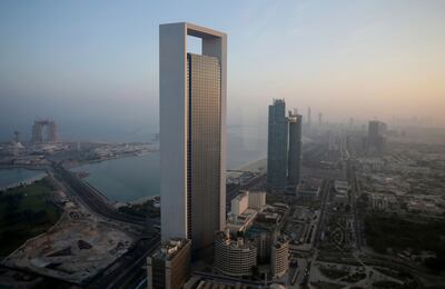 The sun rises over the headquarters of the Abu Dhabi National Oil Company headquarters that dominates the skyline in Abu Dhabi. AP