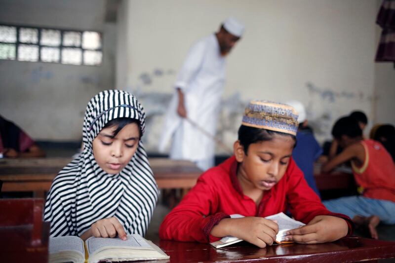 Bangladeshi Muslim children read the holy Koran at the Madrasa in Dhaka. EPA