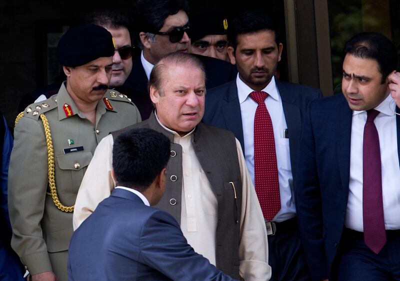 In this June 15, 2017 photo, Pakistan's former Prime Minister Nawaz Sharif, second from left, leaves the office of Joint Investigation Team in Islamabad, Pakistan. A Pakistani judge on Thursday, Oct. 26, 2017, issued an arrest warrant for Sharif after he failed to appear in court in the capital, Islamabad to face corruption charges. (AP Photo/B.K. Bangash)