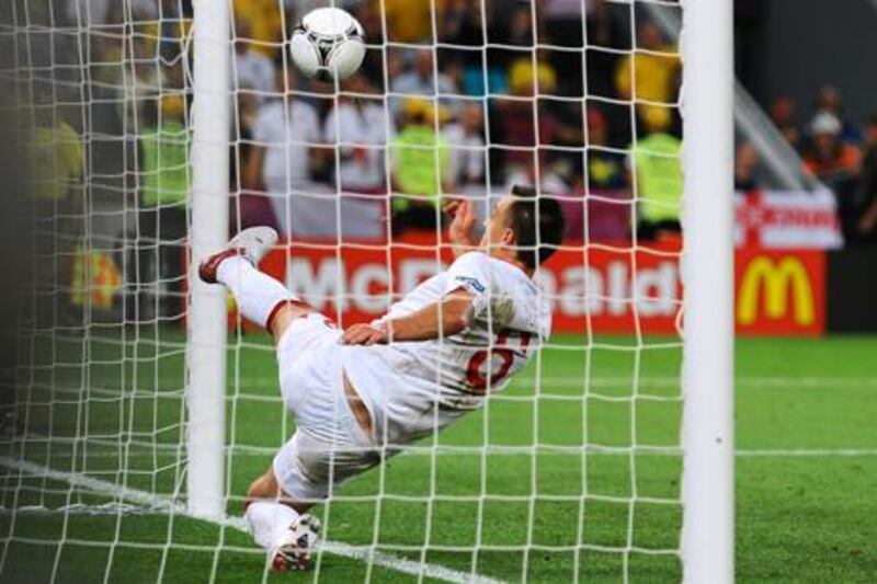 DONETSK, UKRAINE - JUNE 19:  John Terry of England clears an effort from  Marko Devic of Ukraine off the line during the UEFA EURO 2012 group D match between England and Ukraine at Donbass Arena on June 19, 2012 in Donetsk, Ukraine.  (Photo by Laurence Griffiths/Getty Images)