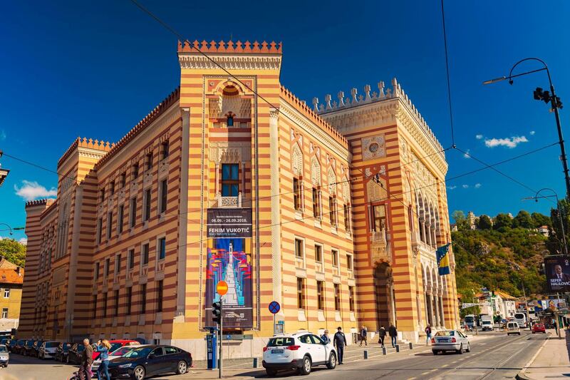 Sarajevo, Bosnia and Hercegovina – September 26, 2018: The City Hall was solemnly opened April 20, 1896, used for governing and administrative purposes. After the Second World War City Hall was put on disposal to the National Library and remains in that function until the aggression against BiH. In the night between August 25 and 26, 1992, City hall was hit by flammable artillery missiles. The fire destroys the City Hall, together with the huge library fund of the National-University Library of about 2 million units. The renovation of the City Hall starts in 1996 and lasts until 2014, and the complete reconstruction has been done according to the original documentation. The reconstructed City hall is officially opened on May 9, 2014 on Day of Europe and the Day of Victory over Fascism. Today, it is used in festive occasions at the state and city level to promote events from culture, art and economy, with constant and occasional museum settings, regular sessions of the City Council, and the variety of usage seems to be bigger than ever before. Getty Images