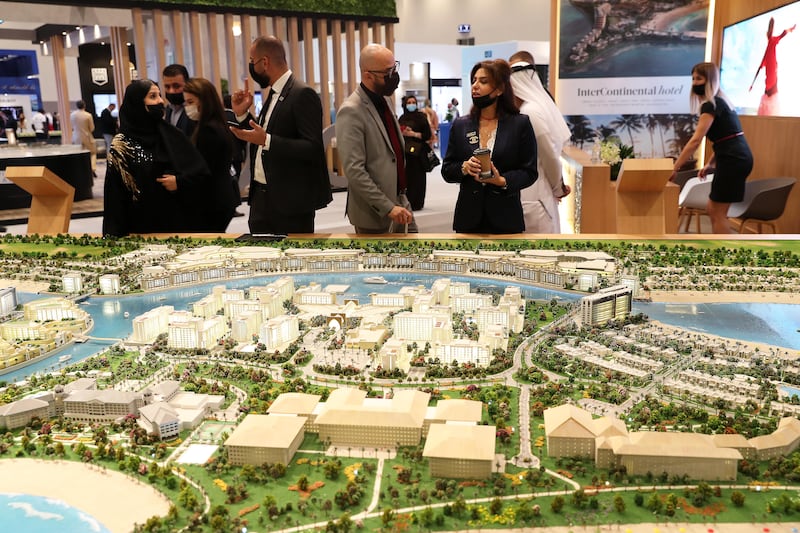 Visitors at the RAK properties stand looking at the model of Mina Al Arab project in Ras Al Khaimah on the first day of Cityscape Global held at Dubai Exhibition Centre in Dubai on Tuesday. Pawan Singh/The National.