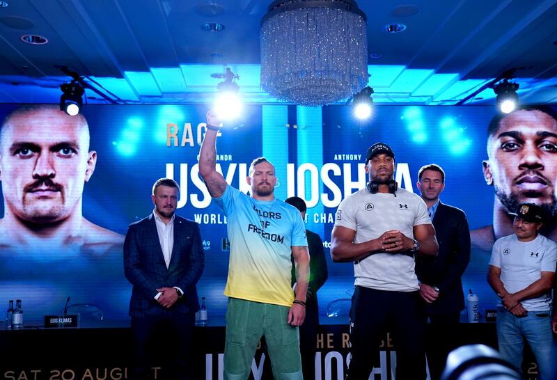 Oleksandr Usyk and Anthony Joshua on stage. PA