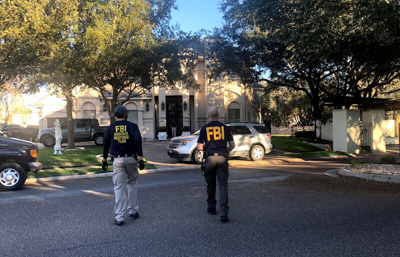 Federal agents search the home of Henry Cuellar in Laredo, Texas. AP