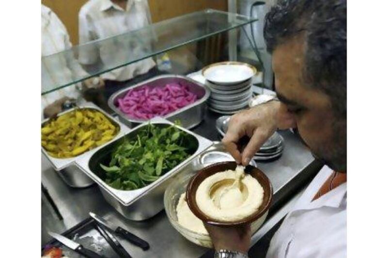 A Lebanese chef prepares a dish of hummus. The country's cuisine is sought after by global consumers.