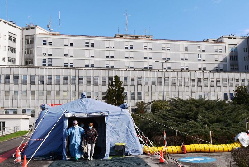 A woman leaves the a pre-triage medical tent in front of the Cremona hospital, in Cremona, northern Italy.  AFP