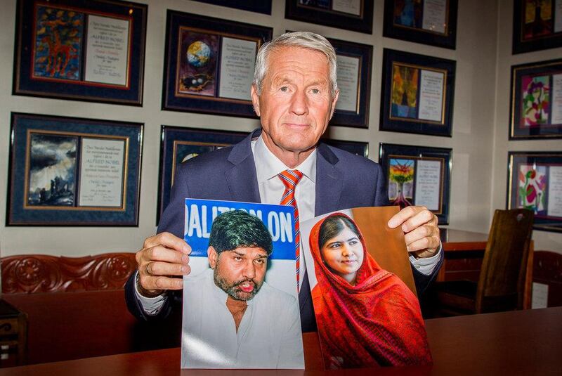 Chair of the Norwegian Nobel Committee, Thorbjorn Jagland holds photos of children’s rights activists Malala Yousafzai of Pakistan, right, and Kailash Satyarthi of India, winners of the Nobel Peace Prize 2014. Vegard Wivestad Grott, Scanpix / AP Photo