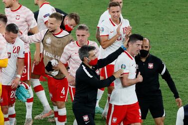 Poland's Robert Lewandowski and teammates celebrate after the draw with Spain. Reuters