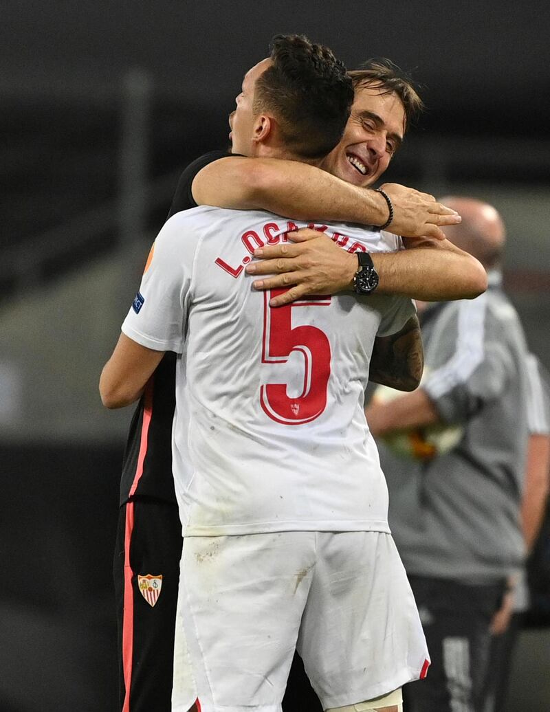 Sevilla's head coach Julen Lopetegui, right hugs Lucas Ocampos. AP