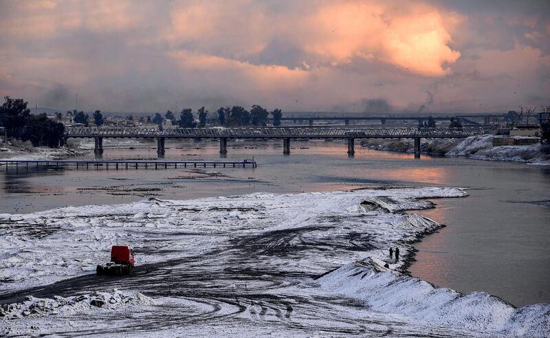 A view of the "Old Bridge" (also known as the "Iron Bridge" or the "First Bridge") in Iraq's northern city of Mosul following a heavy snow storm.   AFP