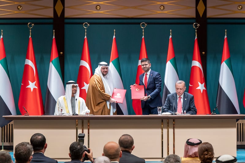 Sheikh Mohamed and Mr Erdogan at the ceremony, where an agreement was signed between Mohamed Al Suwaidi, chief executive of the Abu Dhabi Developmental Holding Company and Burak Daglioglu, president of the Turkey Investment Office. Abdulla Al Neyadi / Ministry of Presidential Affairs