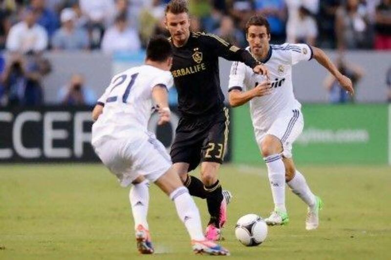 CARSON, CA - AUGUST 02: David Beckham #23 of Los Angeles Galaxy maneuvers the ball in between Gonzalo Higua‡n #20 and Jos‡© Maria Callej‡³n #21 of Real Madrid during the World Football Challenge at The Home Depot Center on August 2, 2012 in Carson, California. Kevork Djansezian/Getty Images/AFP