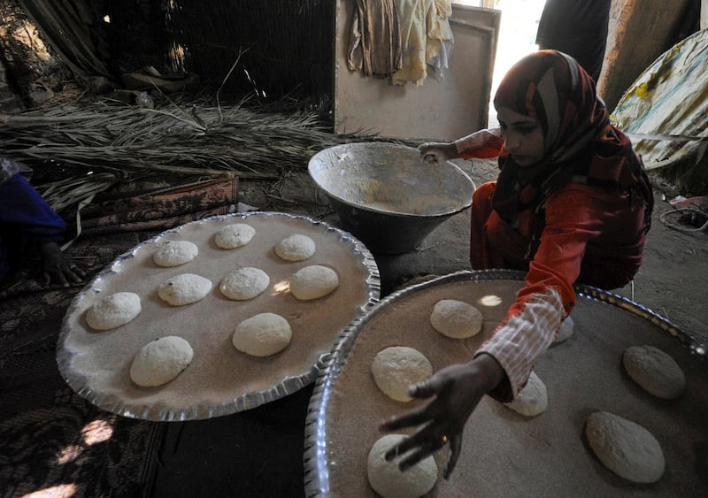 A woman prepares bread for sale to incoming tourists to improve her living conditions in a village at Saqqara, near Giza, Egypt, April 27, 2021. Picture taken April 27, 2021. REUTERS/Shokry Hussien