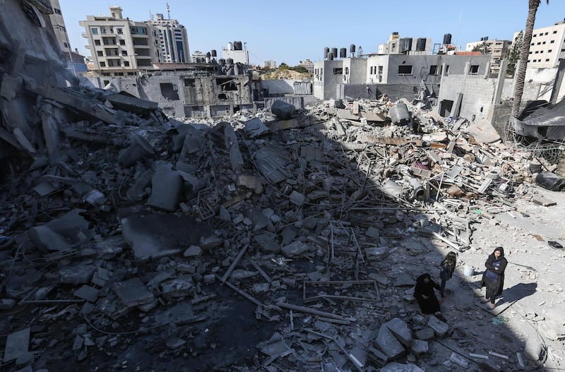 Palestinians gathering next to the rubble of a building in Gaza City. AFP
