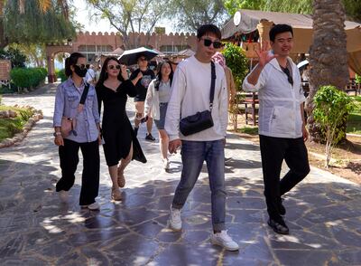 Chinese tourists enjoy the sights at the Heritage Village area in Corniche, Abu Dhabi. Victor Besa / The National