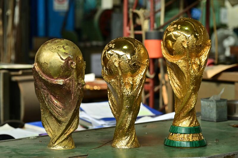 The golden trophy was designed by Italian artist Silvio Gazzaniga on behalf of the firm in 1971. His son Giorgio says it was shaped to maximise its visual impact when held aloft by the winners. AFP
