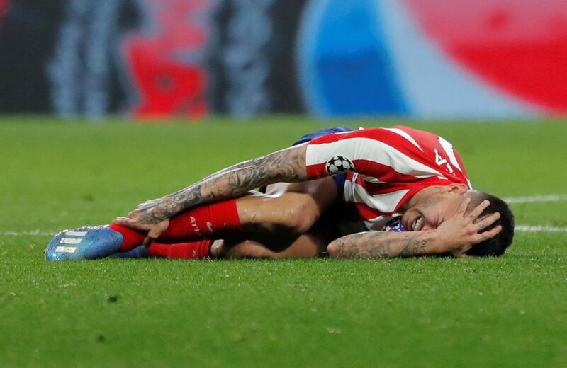 Atletico Madrid's Angel Correa reacts after going down injured. Reuters