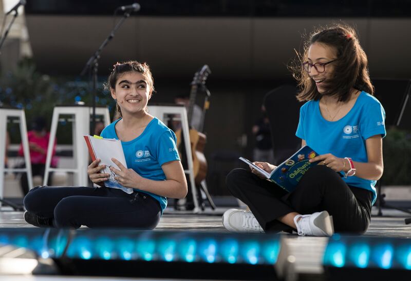 Youths read from books to help celebrate World Children's Day