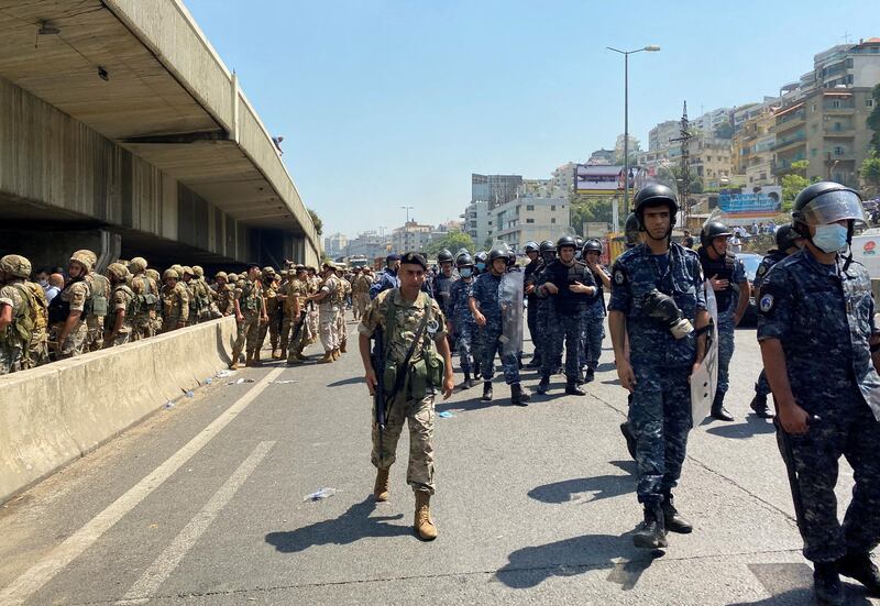 Lebanese soldiers stand guard near protesters in Nahr El Kalb, Lebanon, in the aftermath of attacks on voters. Reuters