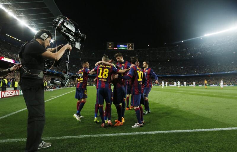 Neymar (hidden) celebrates with teammates after scoring the second goal for Barcelona in their Uefa Champions League quarter-final second leg victory over Paris Saint-Germain on Tuesday at Camp Nou.  Albert Gea / Reuters