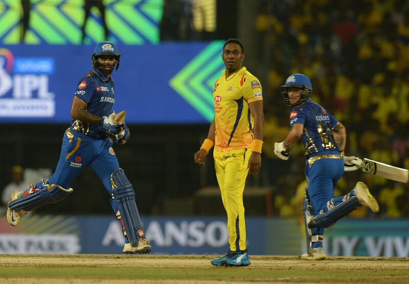 Mumbai Indians cricketer Surya Kumar Yadav (L) and Ishan Kishan (R) run between wickets as Chennai Super Kings Cricketer Dwayne Bravo (C) gestures during the 2019 Indian Premier League (IPL) first Qualifier Twenty20 cricket match between Chennai Super Kings and Mumbai Indians at the MA Chidambaram stadium in Chennai on May 7, 2019. (Photo by ARUN SANKAR / AFP) / IMAGE RESTRICTED TO EDITORIAL USE - STRICTLY NO COMMERCIAL USE