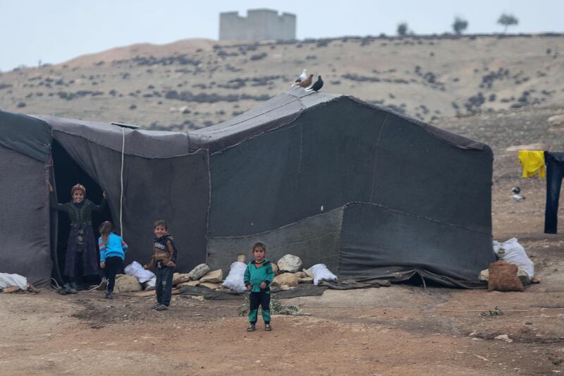 Children play near their tent at the Jabal Bersaya camp. AFP
