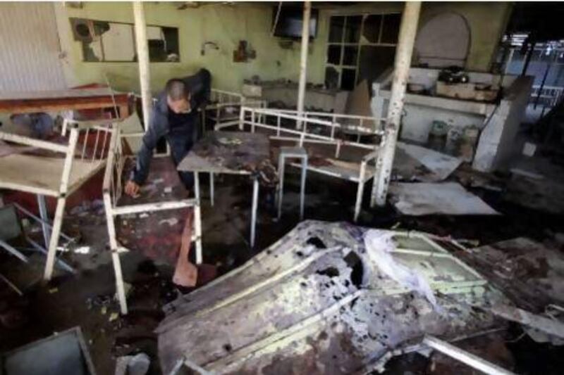 A man inspects damage at a cafe following a suicide bombing in Balad, 80 kilometres north of Baghdad.