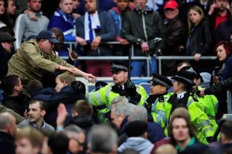 Millwall fans clash with police during the FA Cup semi-final match against Wigan Athletic at Wembley Stadium. Glyn Kirk / AFP