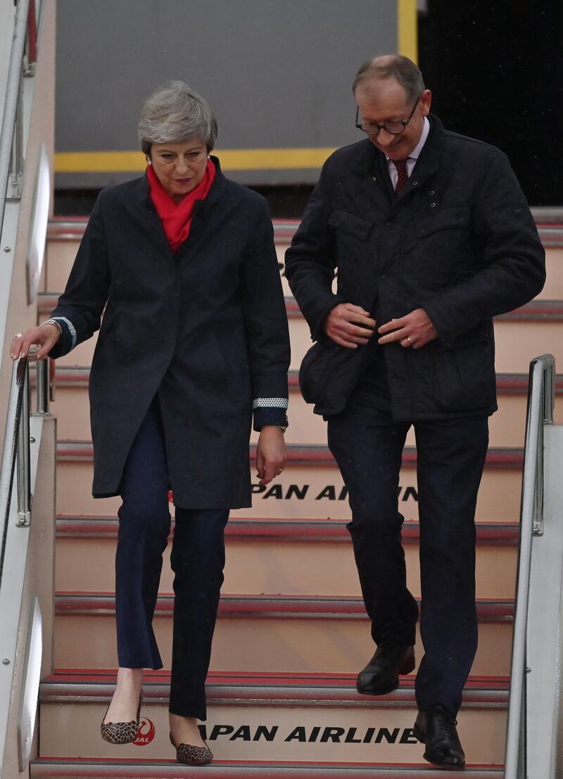 Britain's Prime Minister Theresa May and her husband Philip May arrive at Kansai airport in Izumisano city, Osaka prefecture  ahead of the G20 Osaka Summit. AFP