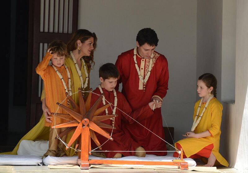 The Trudeaus try out a ceremonial spinning wheel during their visit to Gandhi Ashram in Ahmedabad. Sam Panthaky / AFP Photo