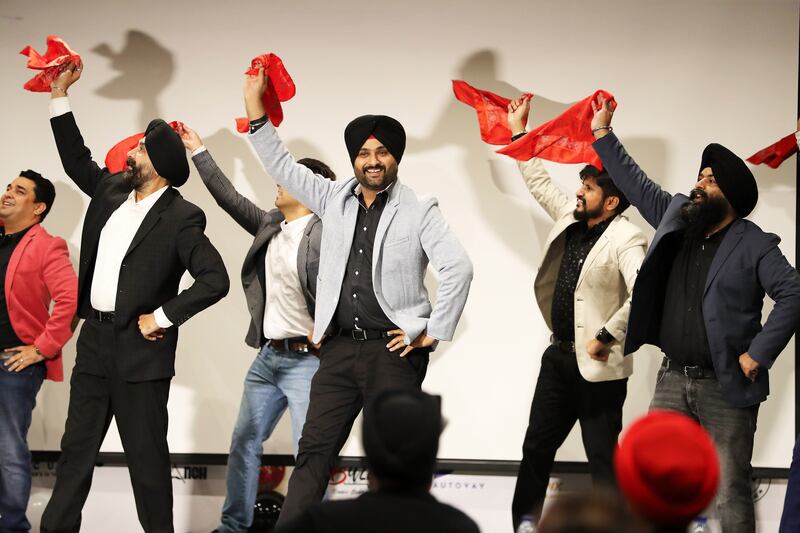 Amandeep Singh, founder of Bhangra Crew Dubai, centre, with members of the Sikh community performing Bhangra.