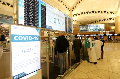 Saudi nationals scan their documents at a digital-Immigration gate at the King Khalid International Airport, after Saudi authorities lifted the travel ban on its citizens after fourteen months due to coronavirus disease (COVID-19) restrictions, in Riyadh, Saudi Arabia, May 16, 2021. REUTERS/Ahmed Yosri