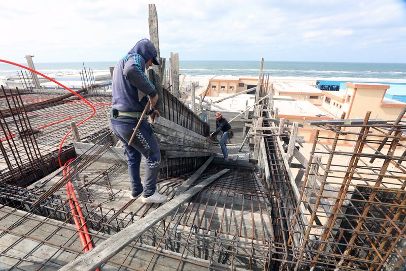 Construction workers at a work site in Arish, Egypt. The IMF says the North African country remains vulnerable to a high public debt burden. EPA