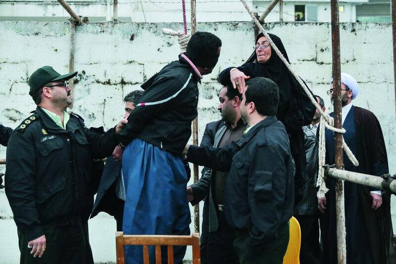 The mother, right, of Abdolah Hosseinzadeh, who was murdered in 2007, slaps Balal, who killed her son, during the execution ceremony in the northern city of Nowshahr in Iran on April 15 just before she removed the noose around his neck with the help of her husband, sparing the life of her son’s convicted murderer. Arash Khamooshi / AFP