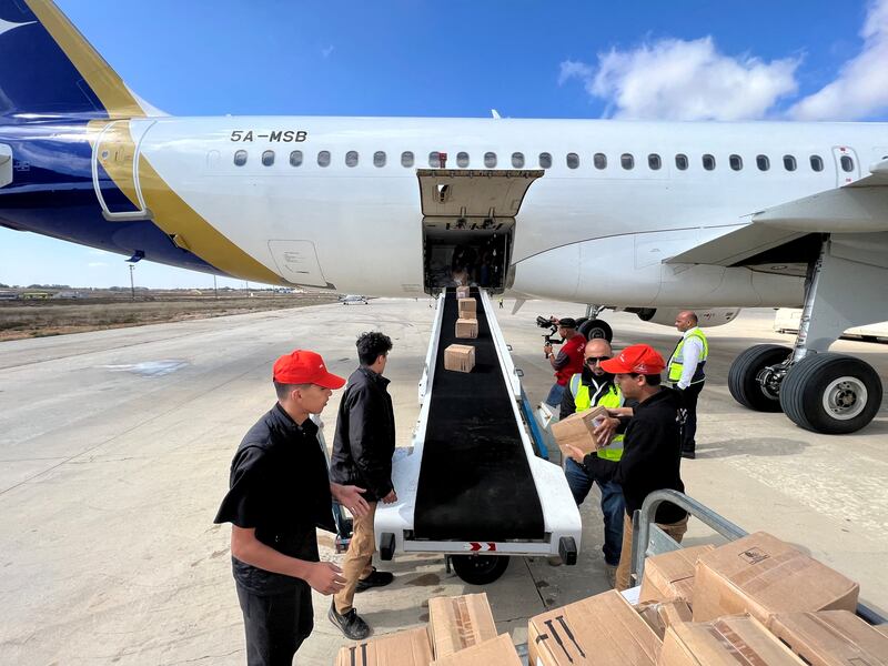 Members of Libya's Youth Hostels Association unload medical aid from a plane at Al Abraq Airport, for the victims of the floods. Reuters